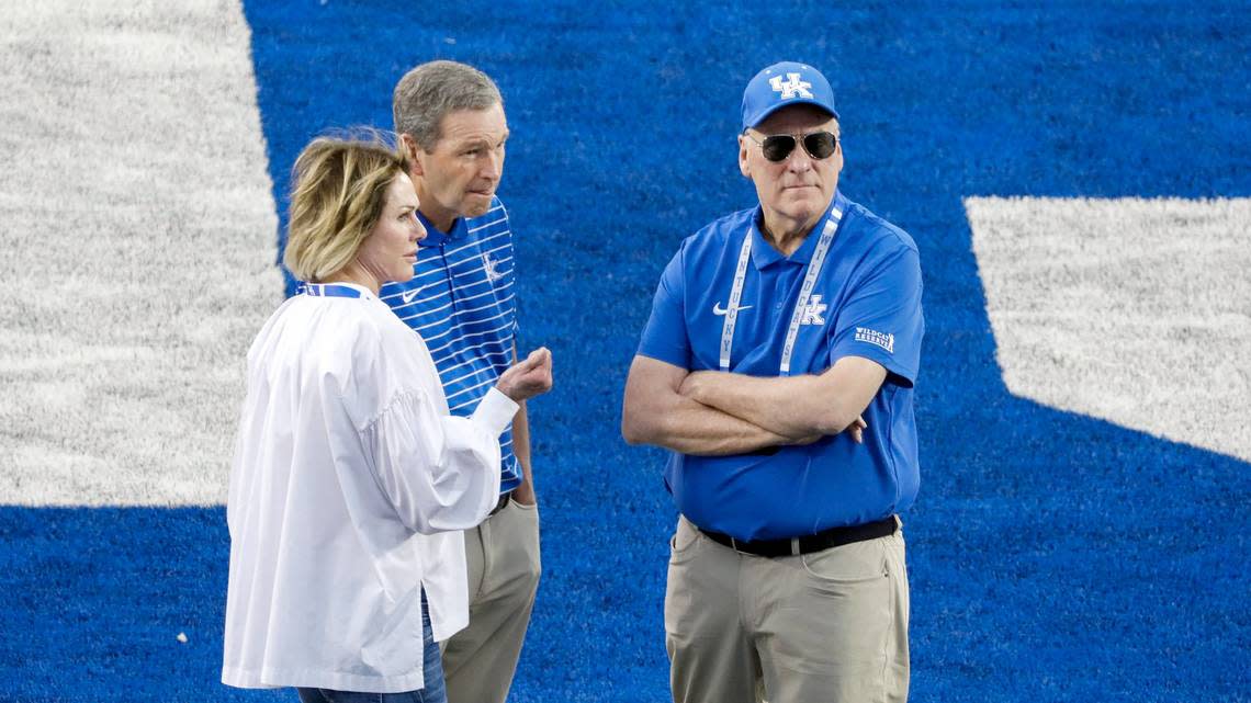 Kentucky Wildcats Athletics Director Mitch Barnhart, center, talks on the field with University of Kentucky donors Joe Craft, right, and his wife, Kelly Craft, left, before a football game against Akron at Kroger Field in Lexington, Ky., Saturday, Sept. 16, 2023.