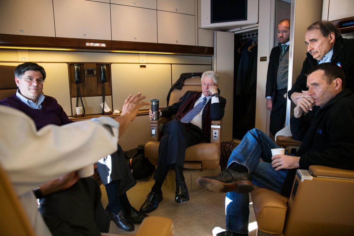 President Barack Obama meets with staff on Air Force One.