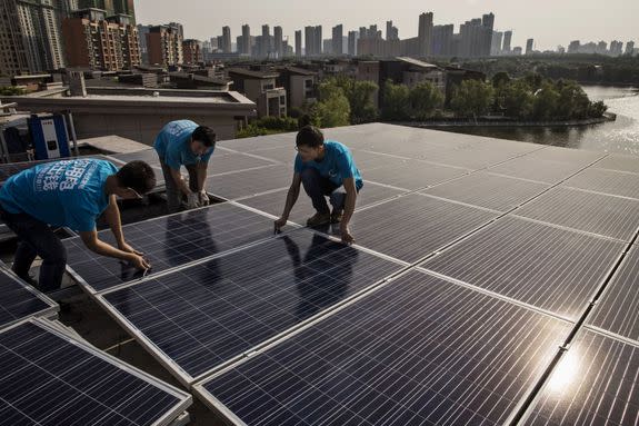 Chinese workers install solar panels in Wuhan, China.