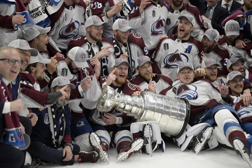 The Colorado Avalanche pose with the Stanley Cup after defeating the Tampa Bay Lightning.