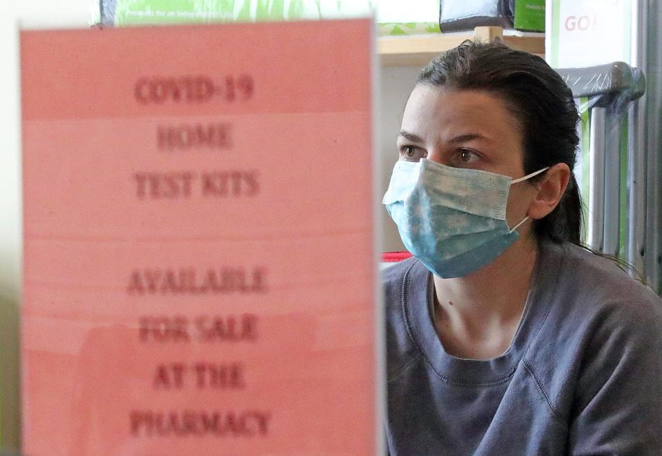 Heather Ciarlariello, 26, sits in the waiting room for 15 minutes after receiving her booster shot at Sand Run Pharmacy on Thursday.