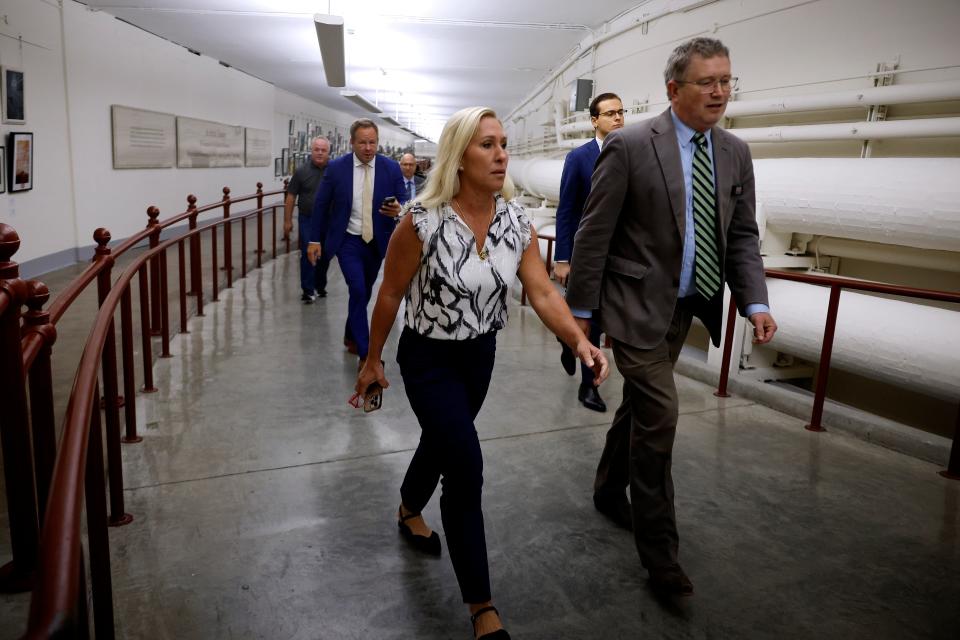 Marjorie Taylor Greene and Thomas Massie walk through the US Capitol to Speaker Mike Johnson’s office on 6 May 2024. Ms Greene is meeting with Mr Johnson on Monday afternoon about her efforts to oust him (Getty Images)