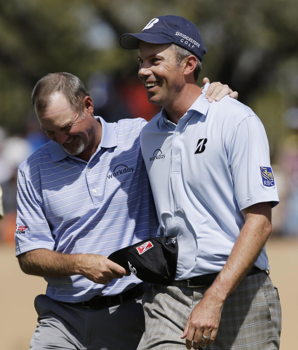 Matt Kuchar, right, walks off the 18th green with playing partner Jerry Kelly, left, after they both birdied the hole during the third round of the Texas Open golf tournament, Saturday, March 29, 2014, in San Antonio. (AP Photo/Eric Gay)