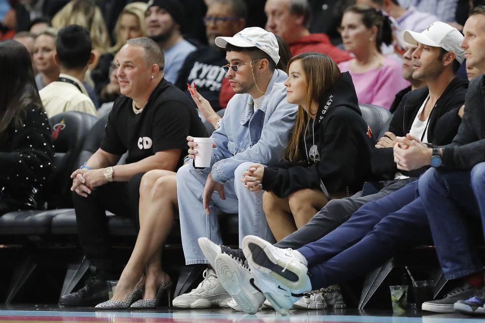 bad bunny and gabriela berlingeri at a miami heat game