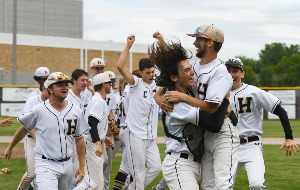 Members of the Holt baseball team celebrate their 4-3 Div. 1 district championship win over Grand Ledge, Saturday, June 4, 2022, at Gorman Field in Grand Ledge.