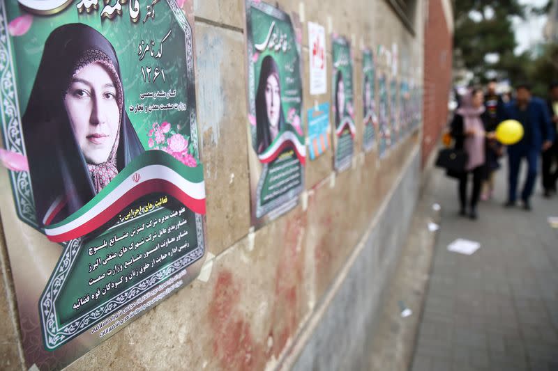 Parliamentary election campaign posters are seen in Tehran