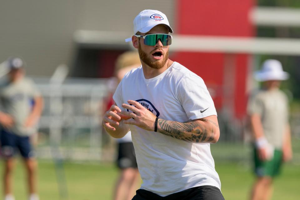 N.C. State quarterback Devin Leary, center, runs a drill with campers at the Manning Passing Academy on the Nicholls State University campus in Thibodaux, La. Friday, June 24, 2022. (AP Photo/Matthew Hinton)