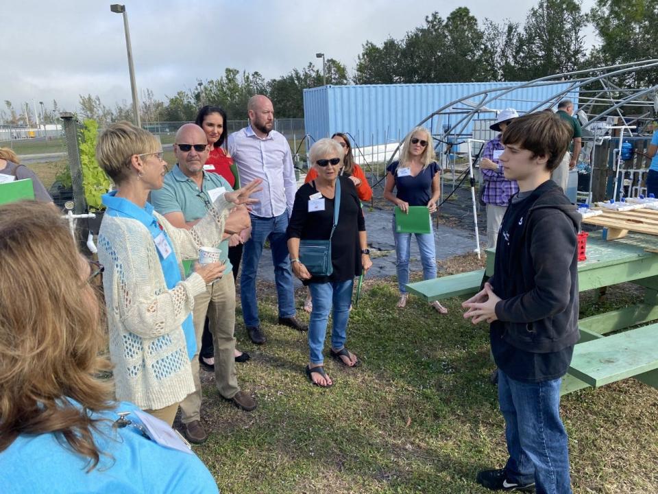 Island Coach High School student and Academy of Natural Resources member Alexander Guthrie fields a question during a tour of the school's garden for area teachers.