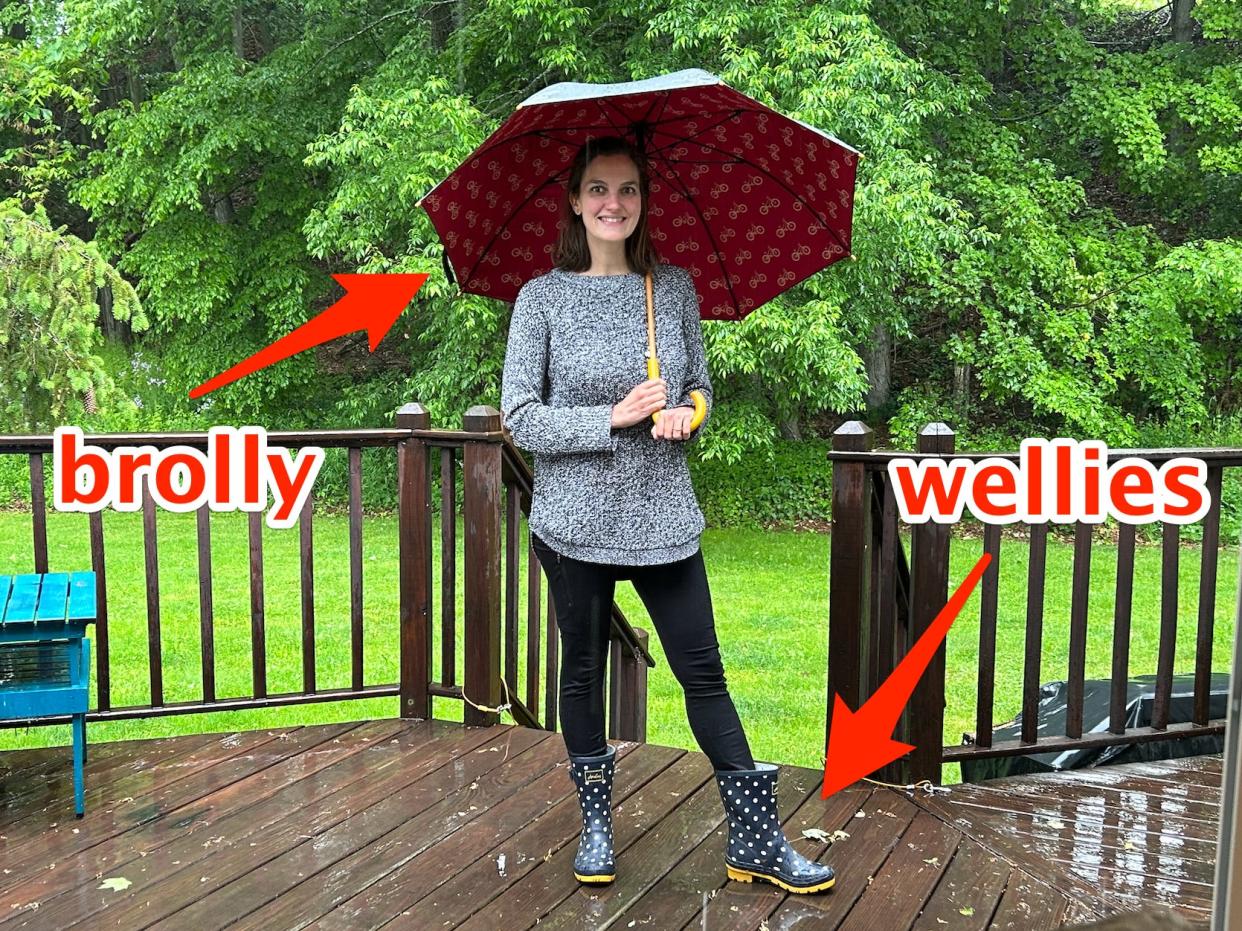 Lydia Warren wearing "wellies" and carrying a "brolly" during rain.