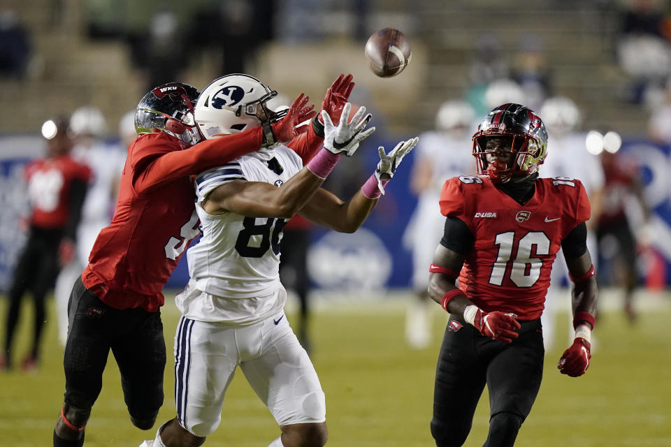 Western Kentucky defensive back Dominique Bradshaw (9) breaks up a pass to BYU wide receiver Keanu Hill (86) as Western Kentucky defensive back Kendrick Simpkins (16) watches during the first half of an NCAA college football game Saturday, Oct. 31, 2020, in Provo, Utah. (AP Photo/Rick Bowmer, Pool)