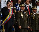 <p>Venezuelan President Nicolas Maduro (L) gestures next to Minister of Defence General Vladimir Padrino (C), during a ceremony to celebrate the 81st anniversary of the National Guard in Caracas on August 4, 2018. (Photo: Juan Barreto/AFP/Getty Images) </p>