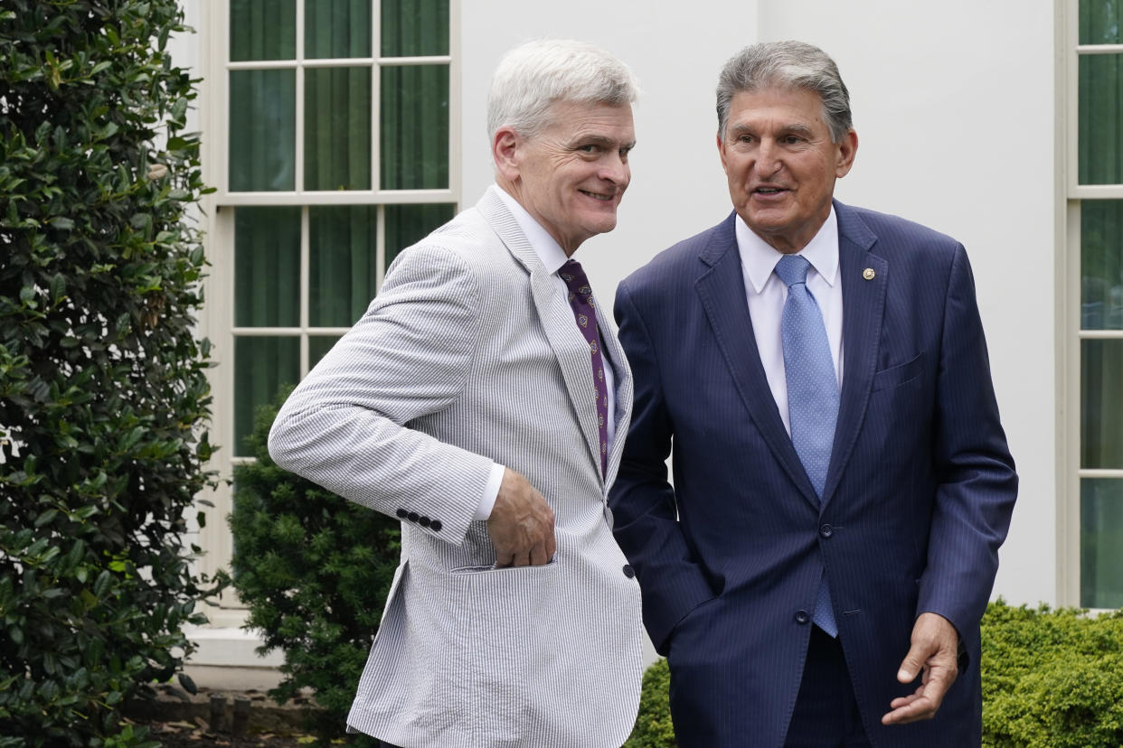 Sen. Bill Cassidy, R-La., and Sen, Joe Manchin, D-W.Va., talk after President Joe Biden, with a bipartisan group of senators, spoke outside the White House in Washington, Thursday June 24, 2021. Biden invited members of the group of 21 Republican and Democratic senators to discuss the infrastructure plan. (AP Photo/Jacquelyn Martin)