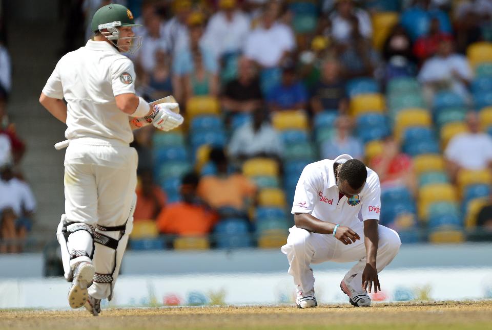 West Indies bowler Kemar Roach (R) reacts as Australian batsman David Warner talks a run during the final day of the first-of-three Test matches between Australia and West Indies at the Kensington Oval stadium in Bridgetown on April 11, 2012. Australia is chasing a target of 192 runs to win the first Test against West Indies. AFP PHOTO/Jewel Samad (Photo credit should read JEWEL SAMAD/AFP/Getty Images)