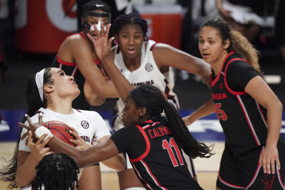 South Carolina guard Brea Beal, left, drives to the hoop against Georgia guard Maya Caldwell (11) during the first half of an NCAA college basketball game Sunday, March 7, 2021, during the Southeastern Conference tournament final in Greenville, S.C. (AP Photo/Sean Rayford)