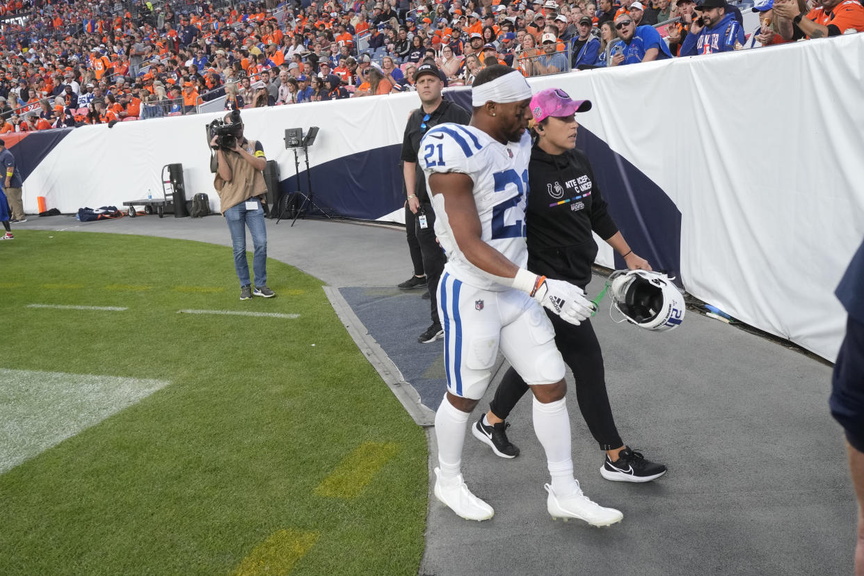 Indianapolis Colts running back Nyheim Hines (21) leaves the field after an injury during the first half of an NFL football game against the Denver Broncos, Thursday, Oct. 6, 2022, in Denver. (AP Photo/David Zalubowski)