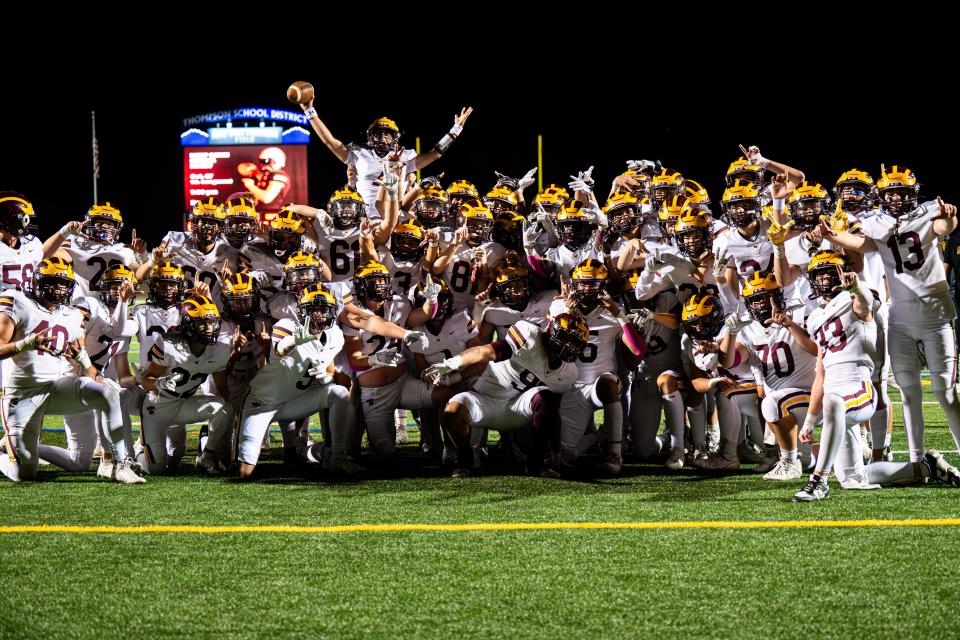 Windsor football players celebrate their 28-10 win against Loveland on Friday at Ray Patterson Field in Loveland.