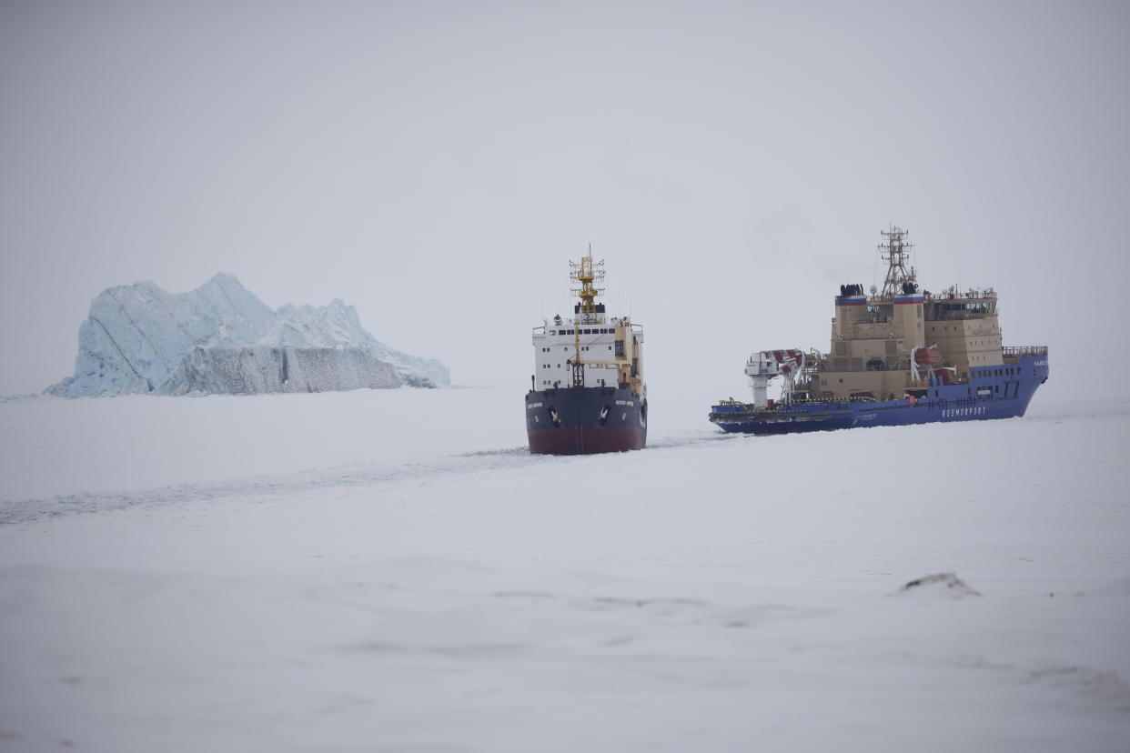 An Icebreaker cuts a path for a cargo ship near Nagurskoye, Russia