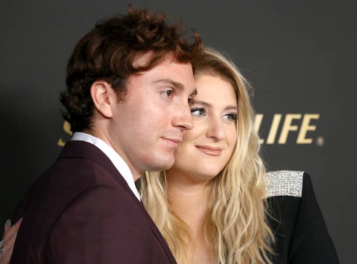 Daryl and Megan posing together for a photo on the red carpet