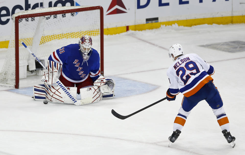 New York Rangers goalie Igor Shesterkin, left, makes the save on New York Islanders center Brock Nelson, right, during the shootout of an NHL hockey game Saturday, April 13, 2024, in New York. (AP Photo/John Munson)