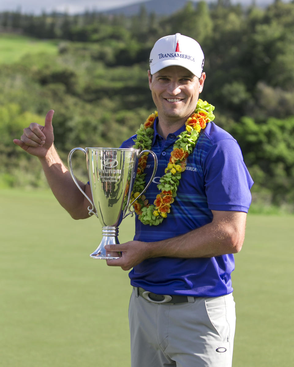 Zach Johnson holds the winning trophy after winning the Tournament of Champions golf tournament, Monday, Jan. 6, 2014, in Kapalua, Hawaii. Johnson pulled away with three straight birdies on the back nine at Kapalua and closed with a 7-under 66 for a one-shot victory over Jordan Spieth on Monday. (AP Photo/Marco Garcia)