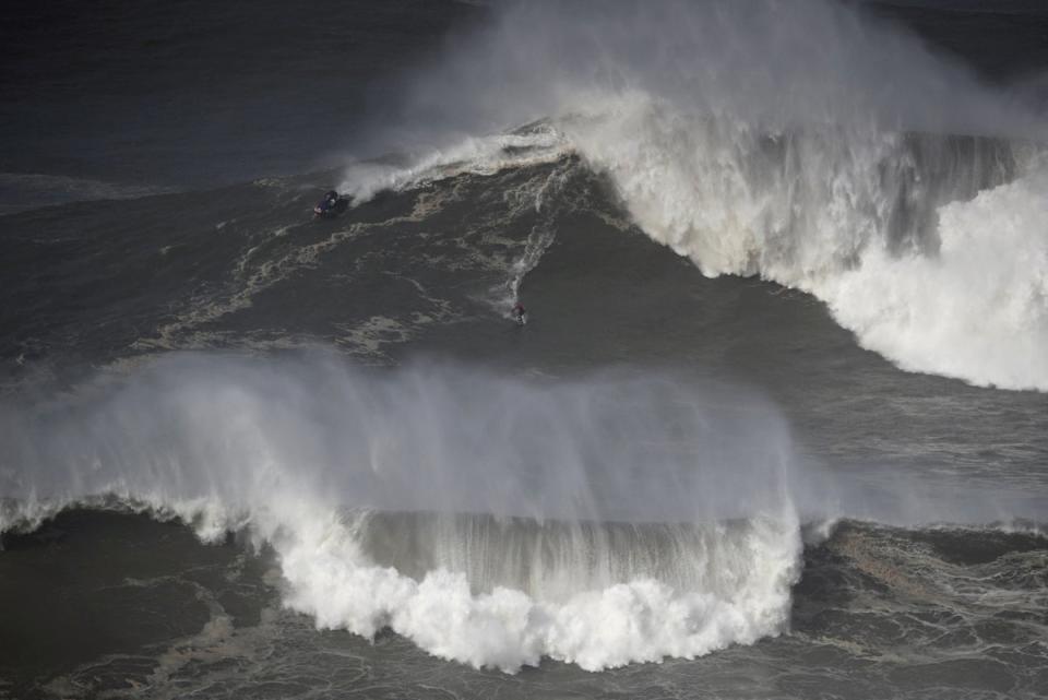 A surfer rides a wave in Nazare, Portugal in February 2022. Marcio Freire died surfing there on Thursday (Reuters)