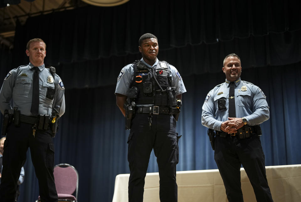 FILE - Officer Jamal Mitchell, center, is presented with a Lifesaving Award by Chief Brian O'Hara in Minneapolis, Minn., during a ceremony on Wednesday Oct. 4, 2023 in Minneapolis. Mitchell, who was responding to a shooting call was ambushed and killed Thursday, May 30, 2024, when he stopped to provide aid to a man who appeared to be a victim. That man instead wound up shooting the officer, authorities said. (Renée Jones Schneider/Star Tribune via AP)