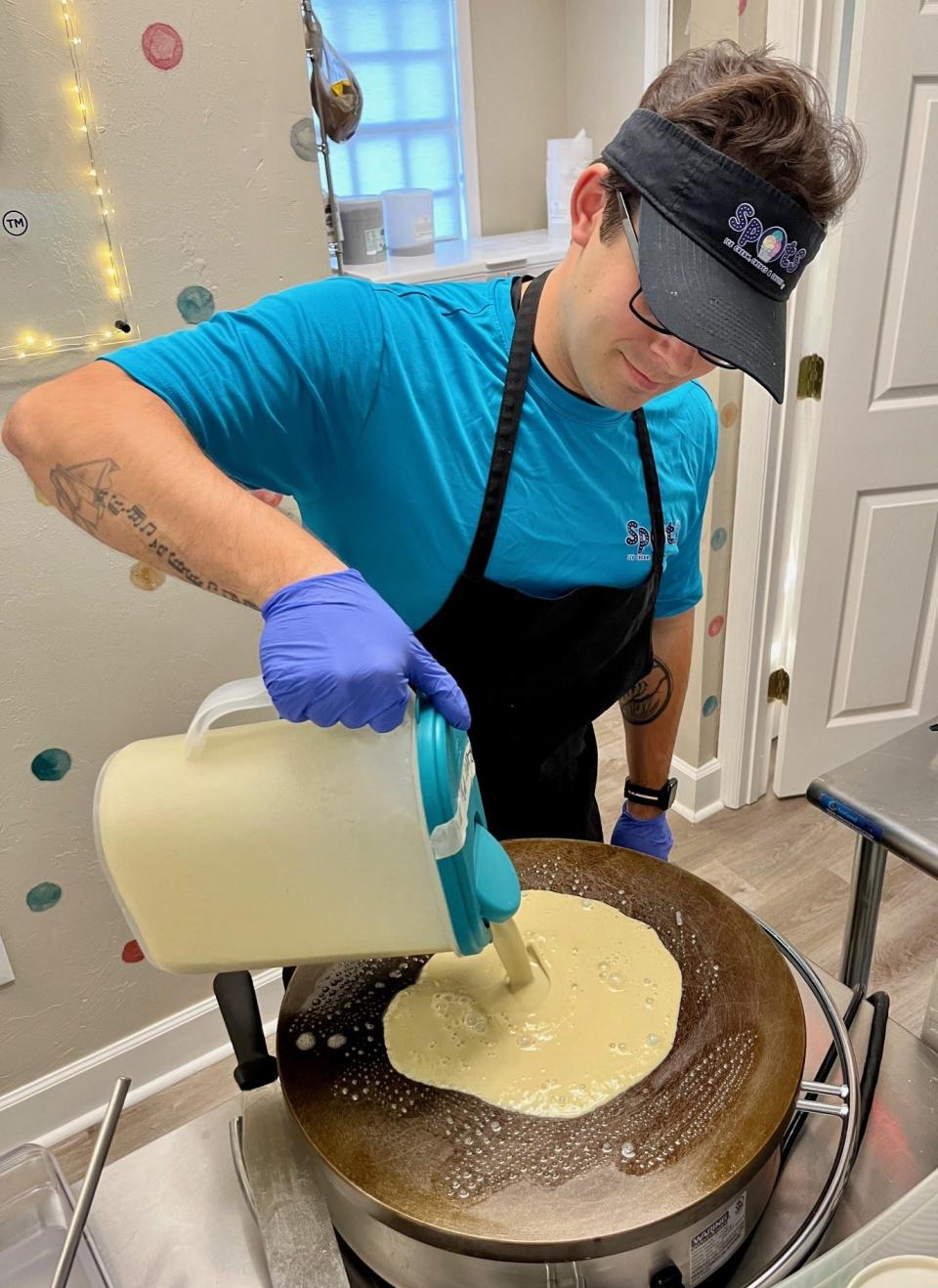 Konnor Newton starts a crepe order at Spots Ice Cream, Crepes & Sauces.