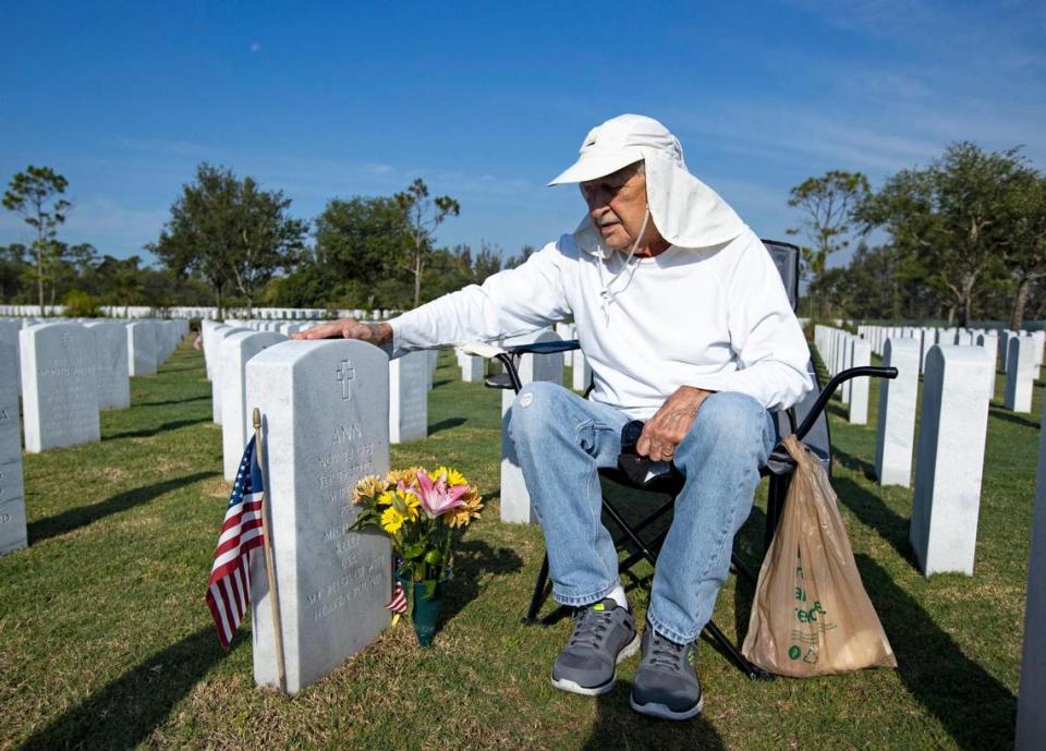 Army veteran Mike Kelly next to his wife’s tombstone at the South Florida National Cemetery Sunday in Lake Worth.