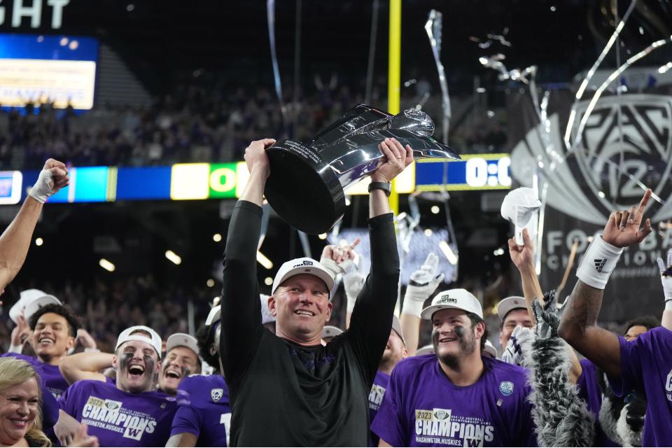 Washington Huskies head coach Kalen DeBoer hoists the Pac-12 championship trophy after victory over the Oregon Ducks in Las Vegas on Dec. 1.