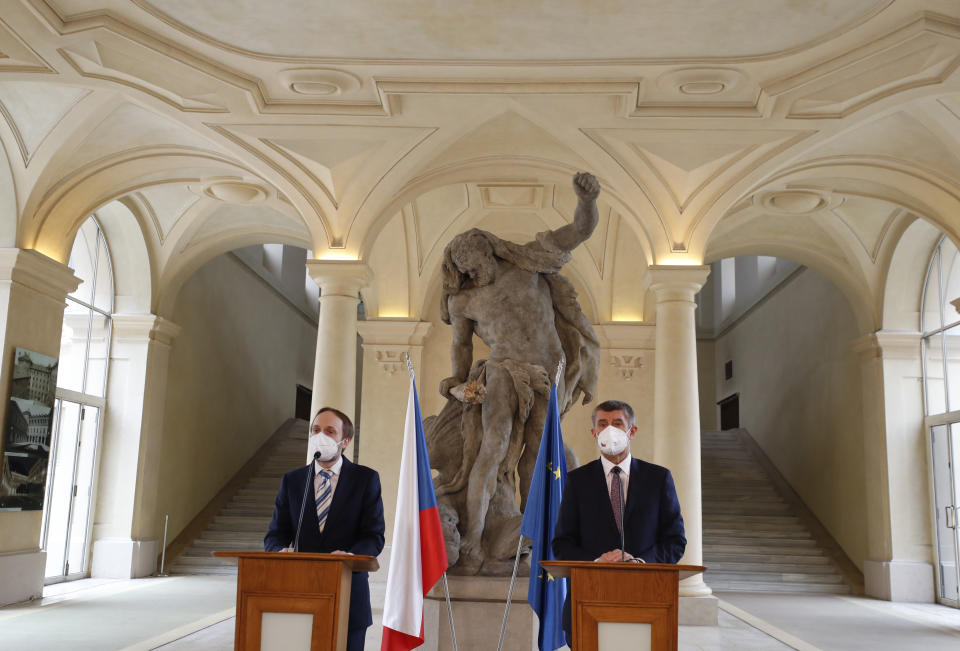 Czech Republic's Prime Minister Andrej Babis, right, and newly appointed Foreign Minister Jakub Kulhanek address media at the Cernin's Palace in Prague, Czech Republic, Wednesday, April 21, 2021. Kulhanek was appointed during a Czech Russia diplomatic crisis over the alleged involvement in a fatal ammunition depot explosion in 2014. (AP Photo/Petr David Josek)