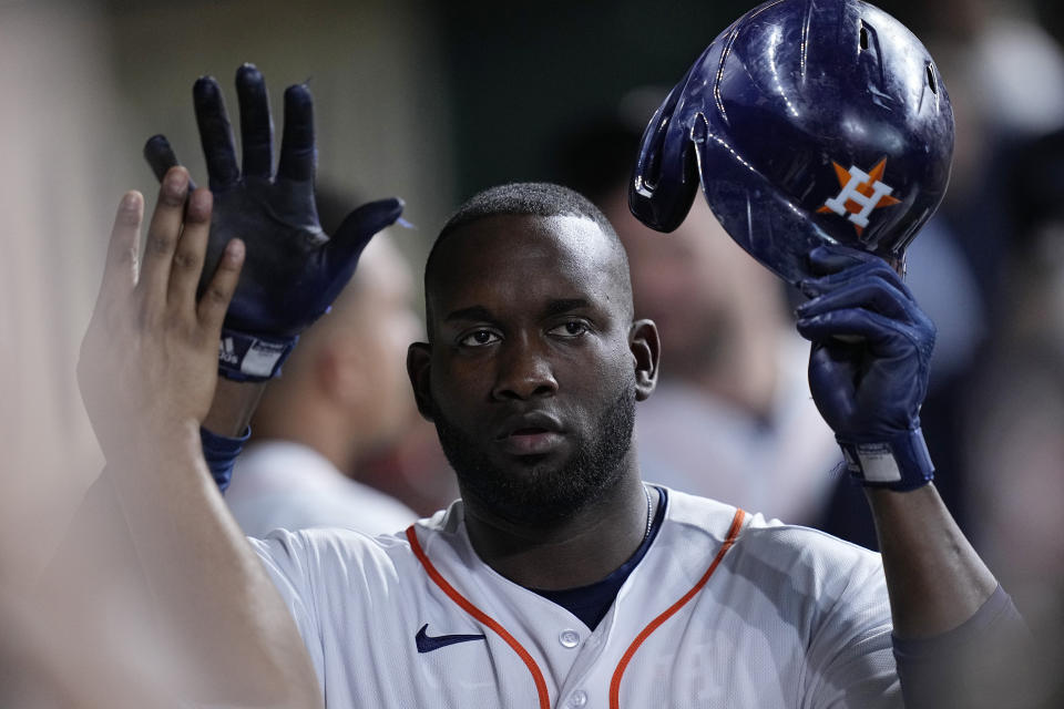 Houston Astros designated hitter Yordan Alvarez is congratulated in the dugout after hitting a solo home run during the third inning of a baseball game against the San Diego Padres, Saturday, Sept. 9, 2023, in Houston. (AP Photo/Kevin M. Cox)