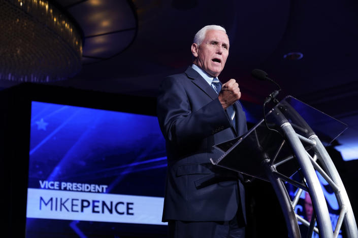 Former Vice President Mike Pence speaks at a podium.