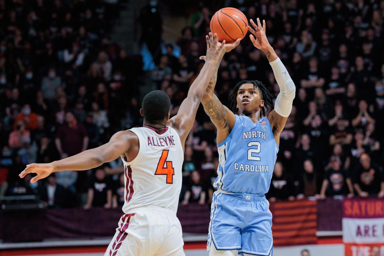 Feb 19, 2022; Blacksburg, Virginia, USA; North Carolina Tar Heels guard Caleb Love (2) shoots over Virginia Tech Hokies guard Nahiem Alleyne (4) during the first half at Cassell Coliseum.