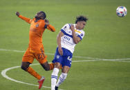 Houston Dynamo FC midfielder Boniek Garcia (27) and San Jose Earthquakes forward Cade Cowell (44) battle for the ball during the first half of an MLS soccer game at BBVA Stadium on Friday, April 16, 2021, in Houston. (Godofredo A. Vásquez/Houston Chronicle via AP)