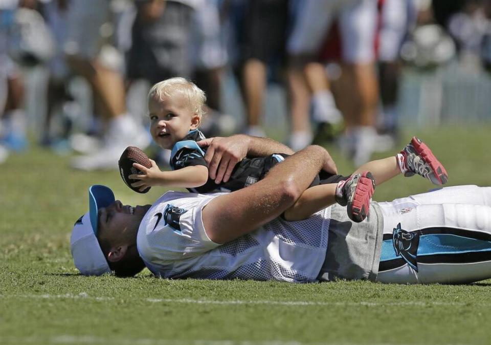 Carolina Panthers’ J.J. Jansen plays with his son, Luke, 2, after practice at the NFL football team’s training camp in Spartanburg, S.C., Sunday, Aug. 2, 2015. (AP Photo/Chuck Burton)