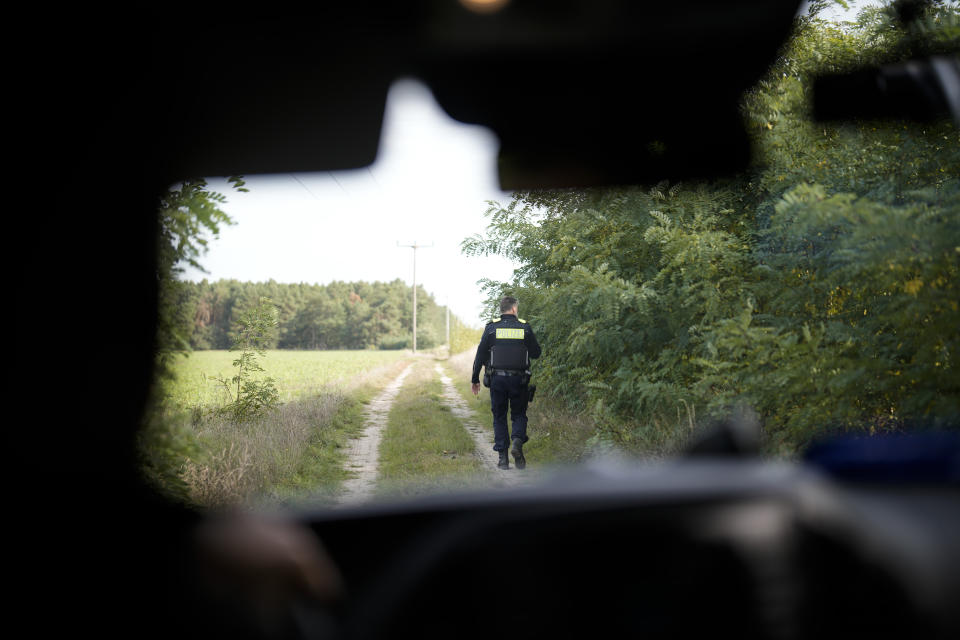 Federal Police officer Frank Malack patrols at during a search for migrants crossing illegally the border from Poland into Germany in a forest near Forst southeast of Berlin, Germany, Wednesday, Oct. 11, 2023. (AP Photo/Markus Schreiber)