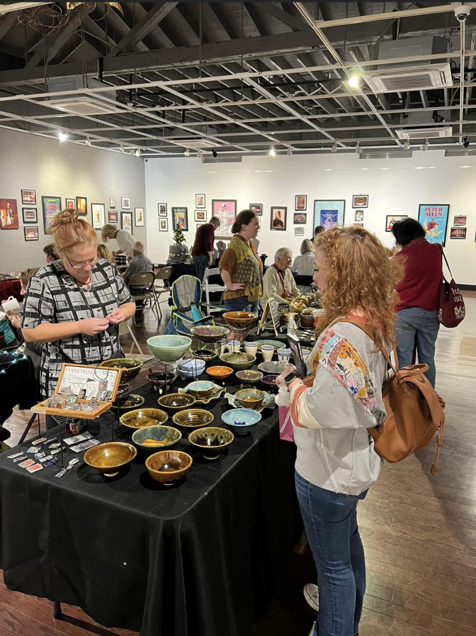 Shoppers peruse a ceramics table at a previous Holiday Bazaar.