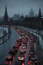 In this Monday, Dec. 10, 2018 photo cars are stuck in a traffic jam on a bank of the Moskva River outside the Kremlin, with the Russian Foreign Ministry building, center in the background, in Moscow, Russia. (AP Photo/Pavel Golovkin)