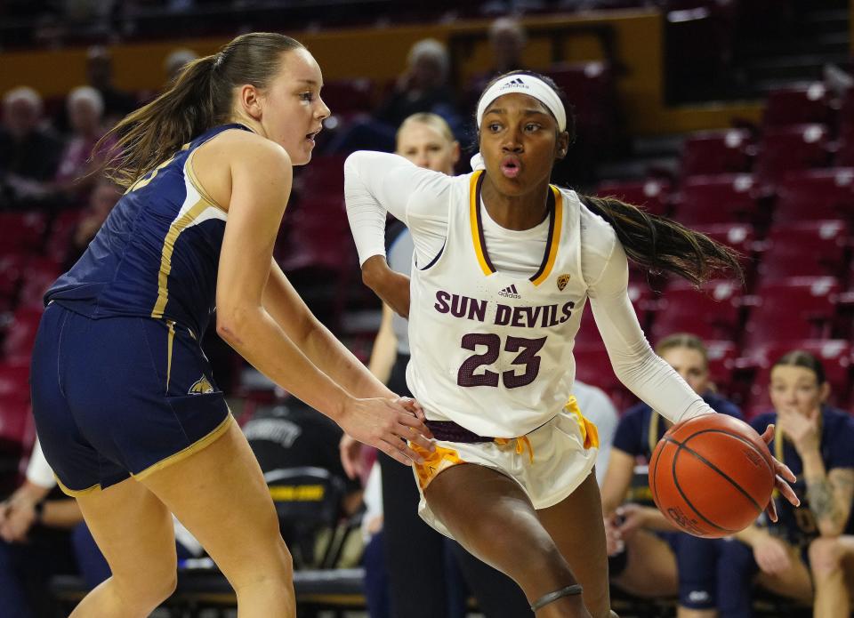 ASU guard Jalyn Brown (23) drives past Montana State forward Isobel Bunyan (15) during a game at Desert Financial Arena in Tempe on Nov. 10, 2023.