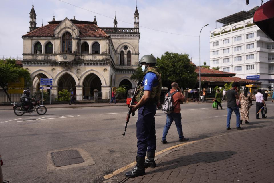 A Sri Lankan navy soldier guards a street during a relaxation in a nationwide curfew that began Monday evening in Colombo, Sri Lanka, Thursday, May 12, 2022. Sri Lanka's president on Wednesday promised to appoint a new prime minister, empower the Parliament and abolish the all-powerful executive presidential system as reforms to stabilize the country engulfed in a political crisis and violence triggered by the worst economic crises in memory. (AP Photo/Eranga Jayawardena)