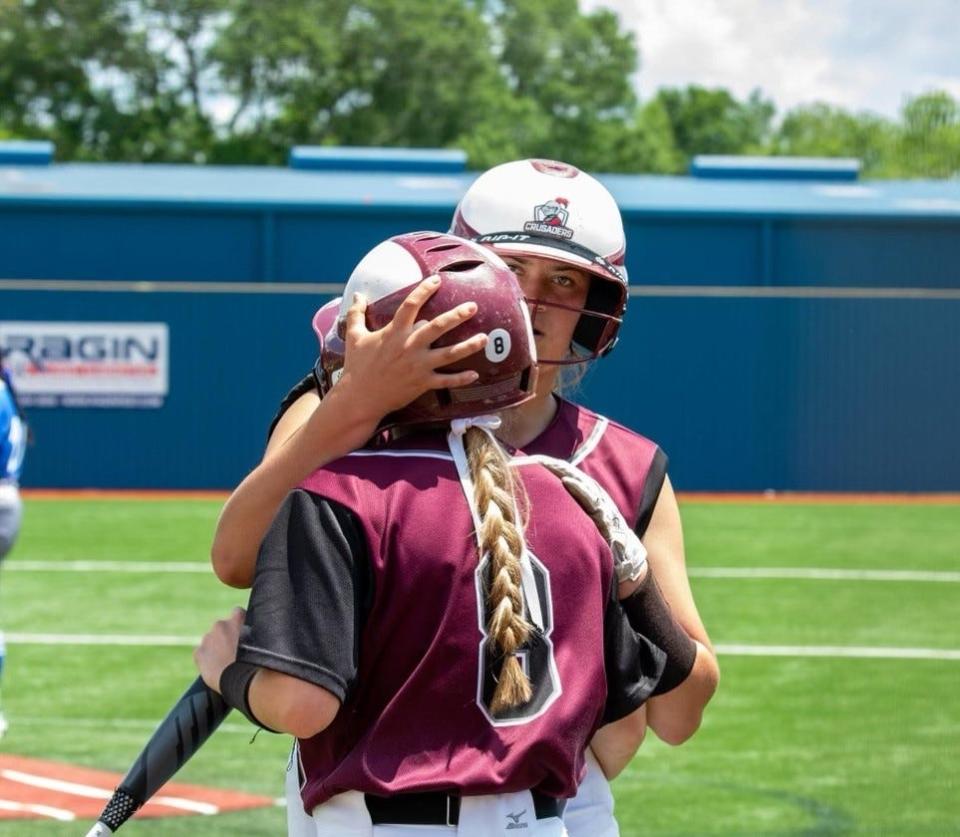 Claiborne Christian's Lily Wainwright gets a hug.