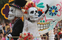 <p>People dressed as skeletons and Mexican popular character Catrina participate in a parade to mark the Day of the Dead in Mexico City, Mexic, Oct. 28, 2017. The Calavera Catrina, or ‘Dapper Skeleton’, is the most representative image of the Day of the Dead, a indigenous festivity that honours ancestors and occurs from 01 to 02 Nov. 1 to 2. (Photo: Mario Guzman/EPA-EFE/REX/Shutterstock) </p>