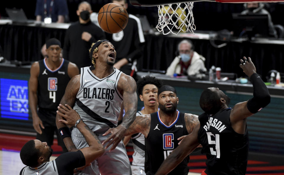 Portland Trail Blazers forward Rondae Hollis-Jefferson, left, blocks the shot of Los Angeles Clippers forward Patrick Patterson, right, during the first half of an NBA basketball game in Portland, Ore., Tuesday, April 20, 2021. (AP Photo/Steve Dykes)