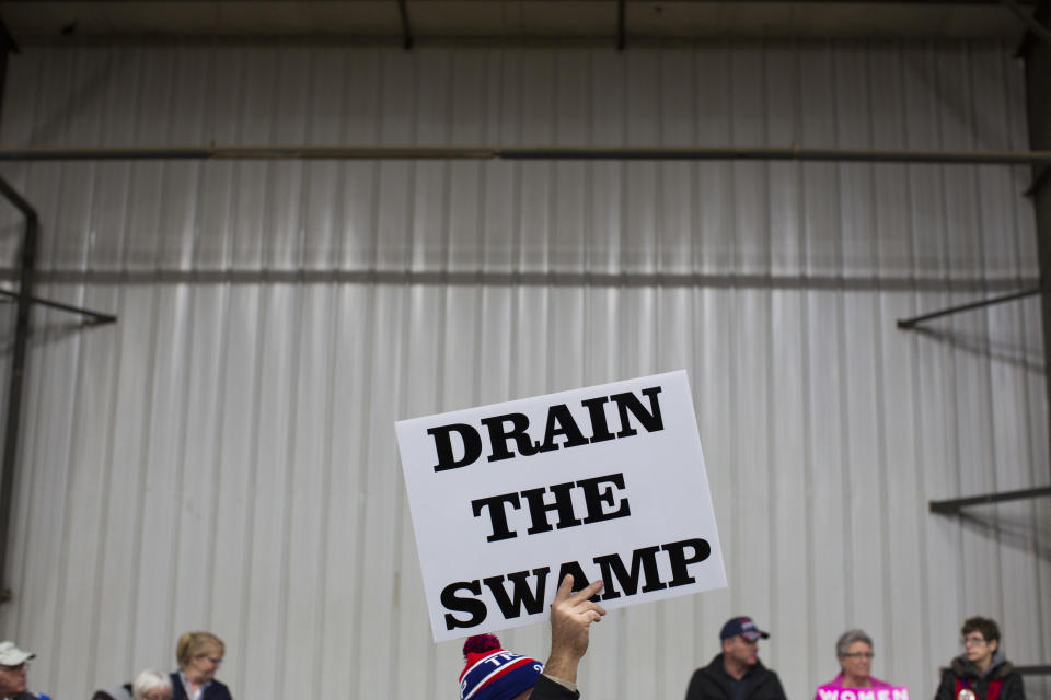 FILE - Supporters of then-Republican presidential candidate Donald Trump hold signs during a campaign rally in Springfield, Ohio, on Oct. 27, 2016. The indictment against Trump involving a payoff to suppress claims of an extramarital affair is raising concerns that it could undermine public confidence in what many see as far more important investigations into whether he attempted to overturn the results of the 2020 presidential election.(AP Photo/ Evan Vucci, file)