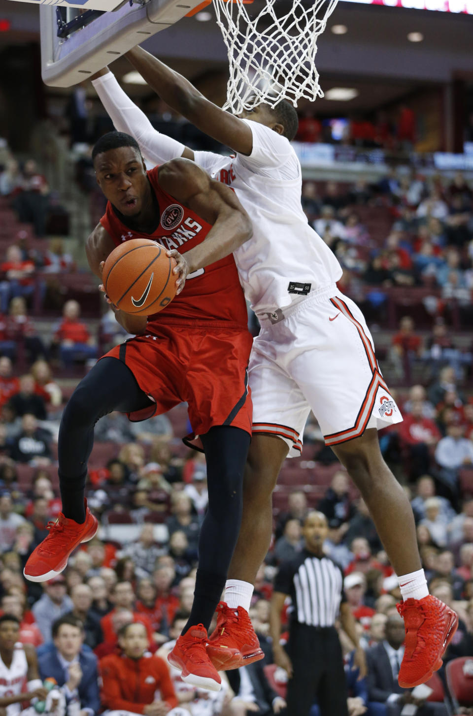 Southeast Missouri State's Quatarrius Wilson, left, passes the ball underneath the basket as Ohio State's E.J. Liddell defends during the first half of an NCAA college basketball game, Tuesday, Dec. 17, 2019, in Columbus, Ohio. (AP Photo/Jay LaPrete)