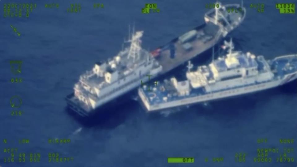 A Chinese militia vessel, top, and the Philippine Coast Guard vessel BRP Cabra approach the Second Thomas Shoal in the disputed South China Sea on Oct. 22, 2023. (Armed Forces of the Philippines via AP)