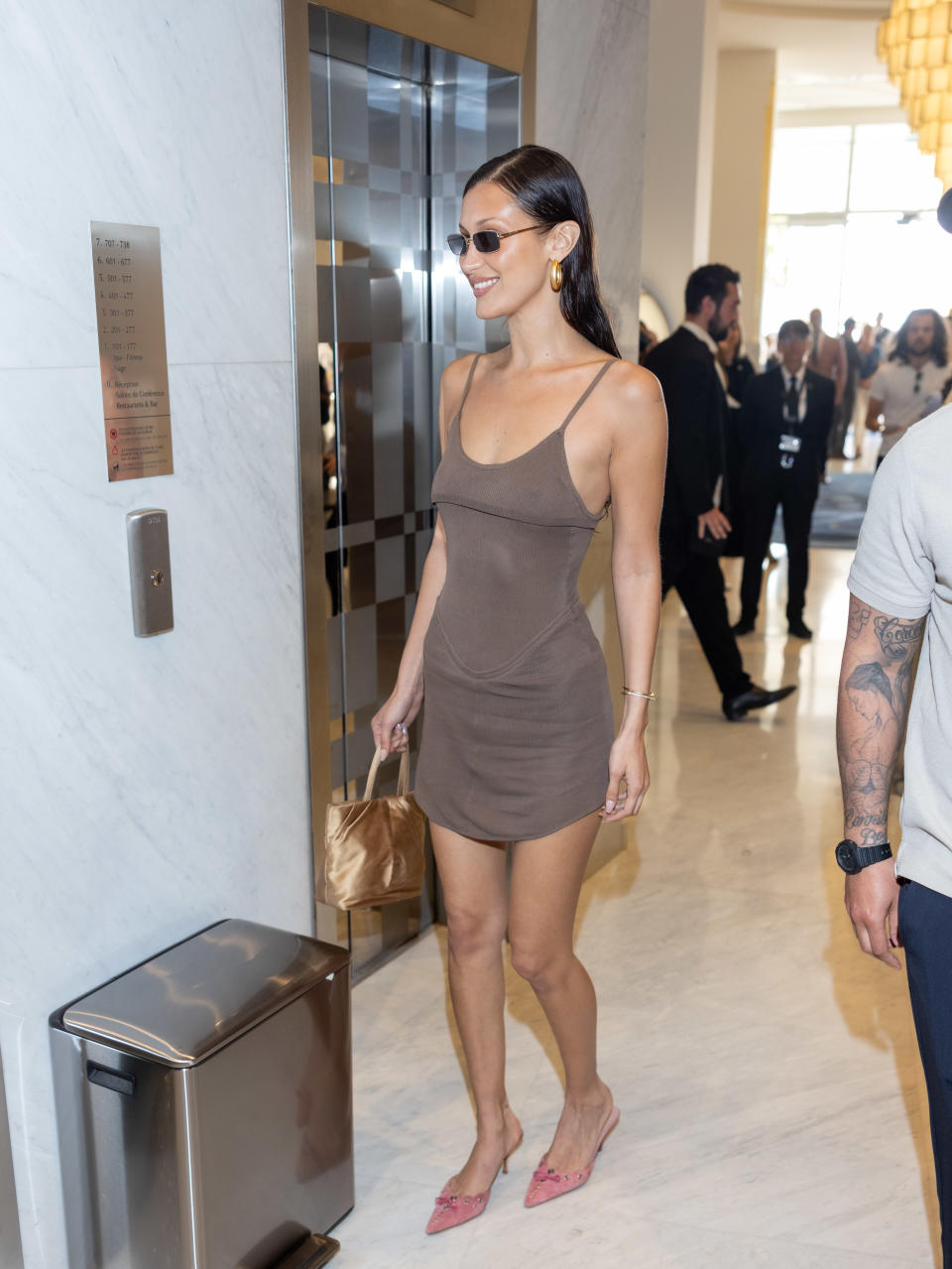 Bella Hadid in a brown mini dress and pink Prada kitten heels at the 2024 Cannes Film Festival