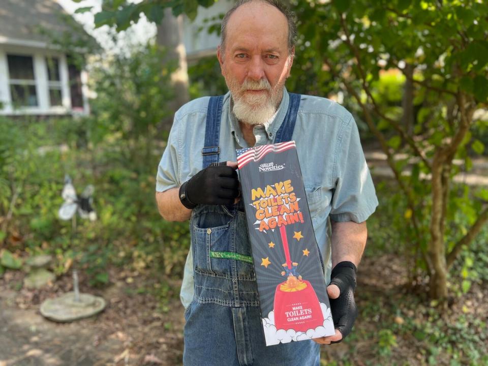 Plumber Glen Davis, a plumber from Asheville, refers to Trump as the 'Orange Satan'. Here he shows off his Trump toilet scrub.  