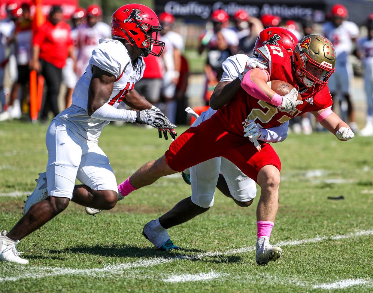 College of the Desert's Kannin Boswell (27) is brought down by Chaffey's Azariah Levells (1) during the first quarter of their game at College of the Desert in Palm Desert, Calif., Saturday, Oct. 21, 2023.