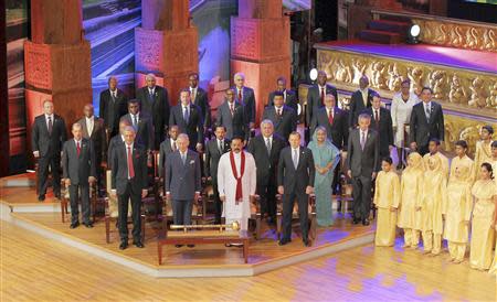 Commonwealth Secretary-General Kamalesh Sharma, Britain's Prince Charles, host Sri Lanka's President Mahinda Rajapaksa and Australia's Prime Minister Tony Abbott (front row L-R) stand with other heads of states during the opening ceremony of the Commonwealth Heads of Government Meeting (CHOGM) in Colombo November 15, 2013. REUTERS/Sri Lankan President's Office/Handout via Reuters